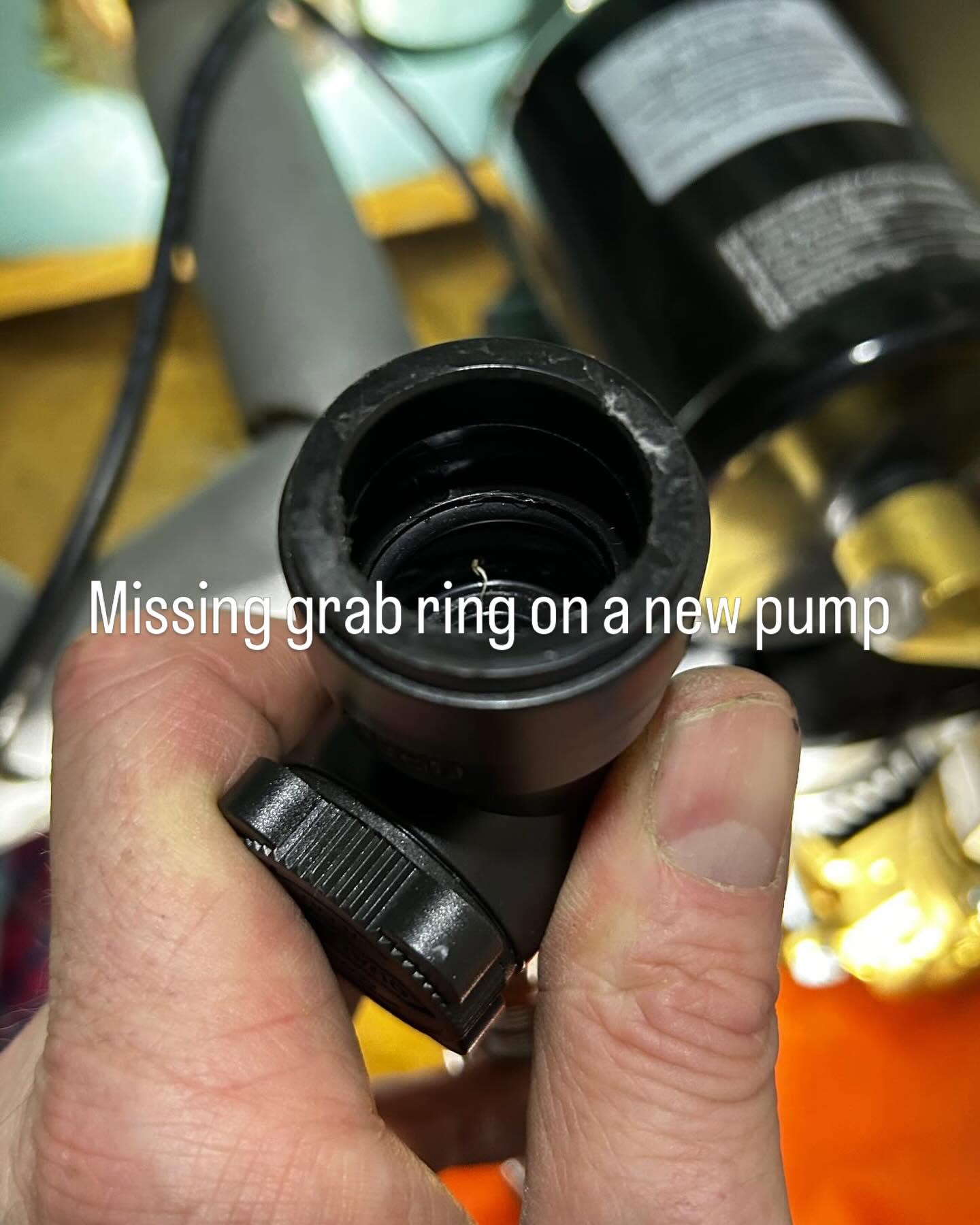 Hand holding a new pump fitting with its grab ring missing