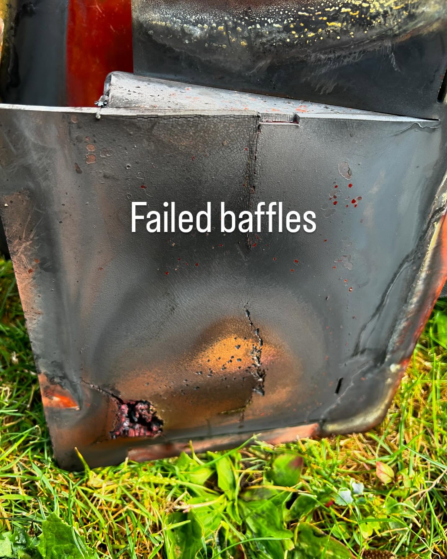Corroded, holed boiler baffles laid on the grass