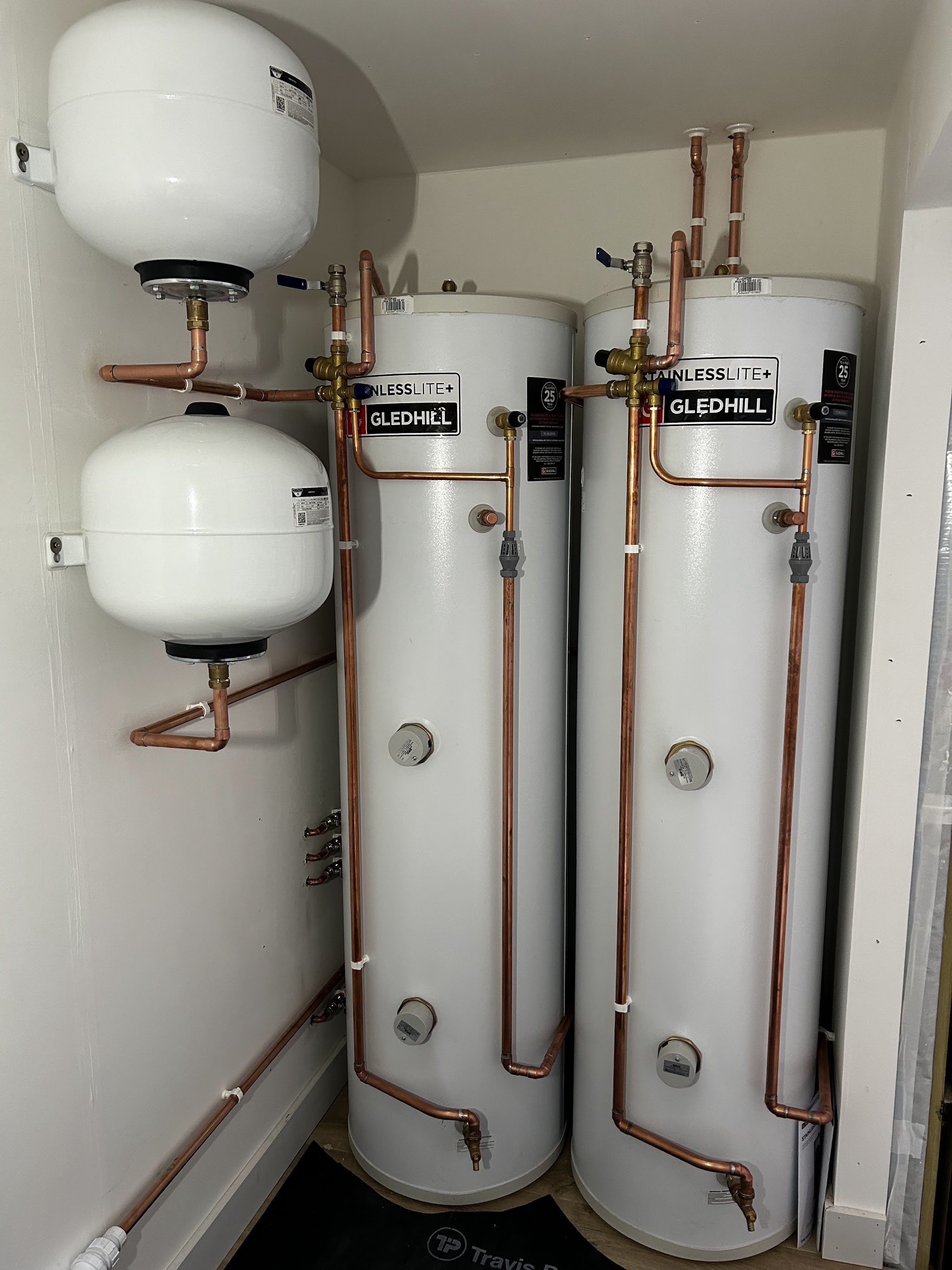 Two Gledhill hot water cylinders with expansion vessels and copper pipework