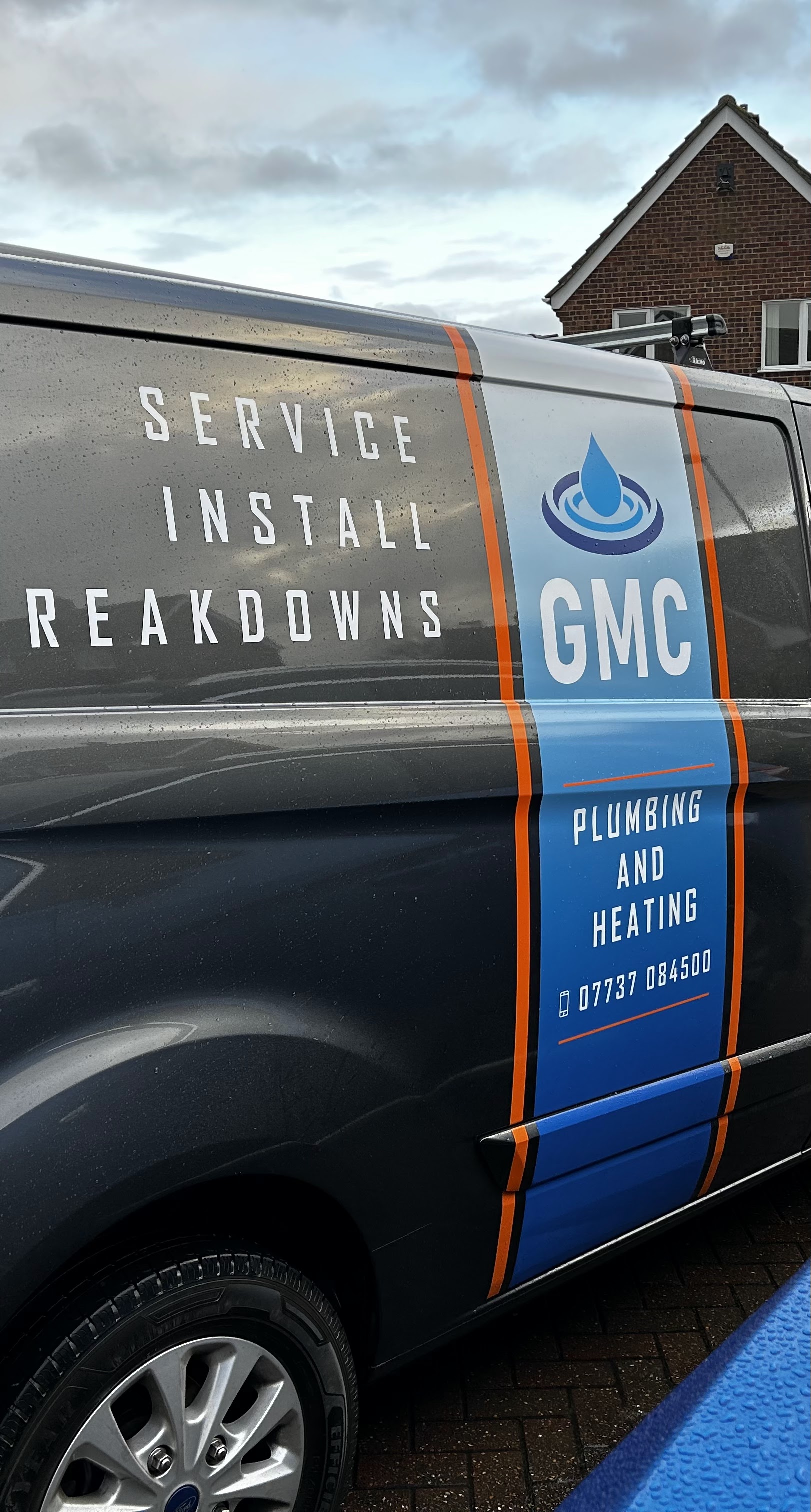 The side of the GMC van with the phone number 07737 084500